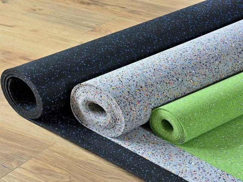 technical blueprint overlaying a roll of rubber flooring